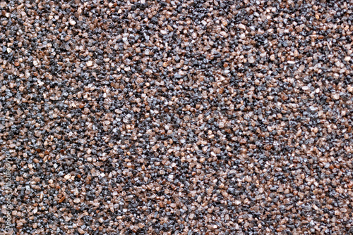 A detailed close up of a pile composed of brown and black gravel