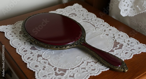 Antique Hand Mirror on Lace Doily: Vintage Beauty, Elegant Vanity Accessory, Ornate Bronze Frame, Reflected Light, Delicate Feminine Touch, Timeless Elegance, Dressing Table Decor