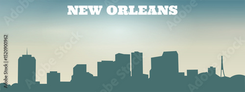 silhouette of the city skyline of New Orleans with several high-rise buildings of different shapes and heights against the background of a bright sky.