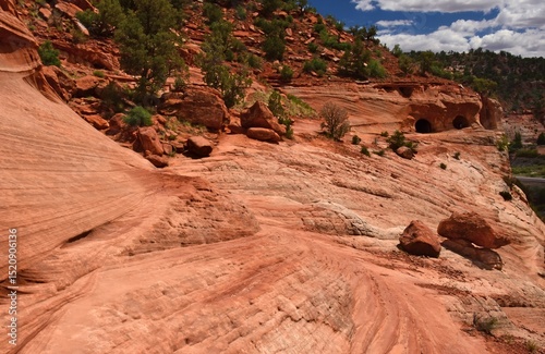 hiking the slick rock out to the man-made kanab sand caves along utah state highway 89. north of kanab, utah, on a sunny summer day