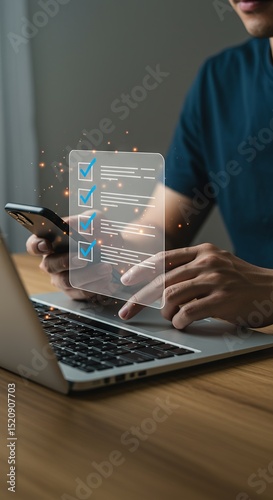 Man completing digital checklist on laptop and phone for task management concept, checklist, task management, online survey, digital form, laptop, mobile phone, technology, business, man, working, pro