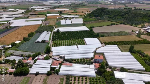 Aerial view of greenhouses and fields creating a geometric pattern in Antalya, Turkey, highlighting intensive farming practices