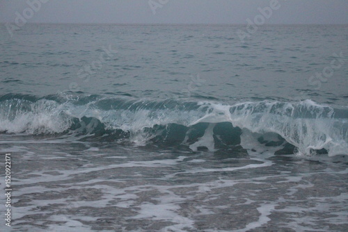 Fototapeta Naklejka Na Ścianę i Meble -  beautiful sea wave in the evening on the beach