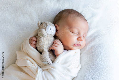 Sweet beautiful baby girl, sleeping in bed with teddy bear, pure colors, infant sleeping 
