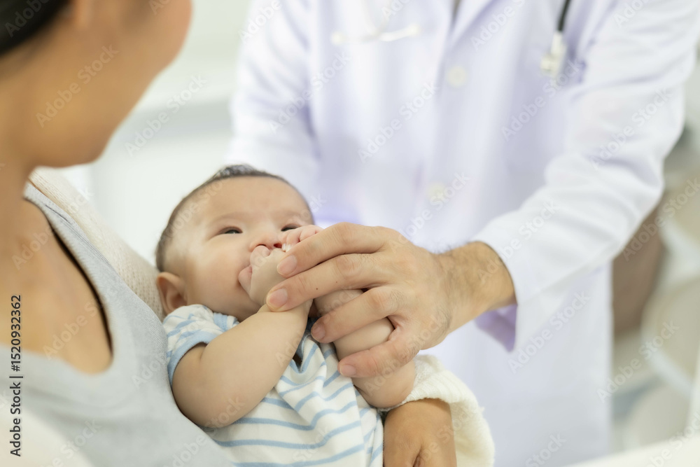 Fototapeta premium The doctor examines the baby by holding and moving the baby in various positions, checking the baby's cries, and using a stethoscope to check the baby's internal symptoms.