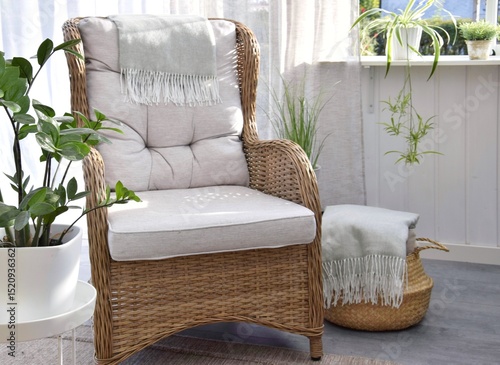 Wicker rattan chair with green indoor plant on the terrace.Relaxation area.