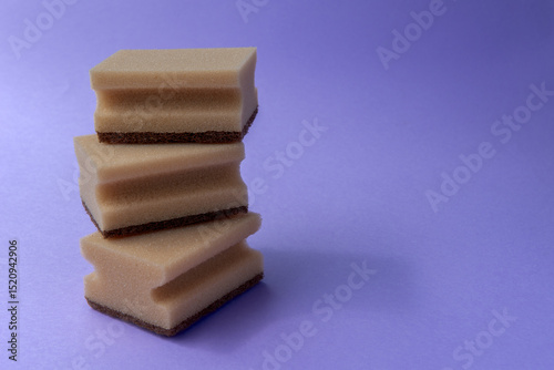 three dish sponges on the violet background