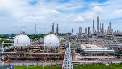 Gas separation plant at industrial estate under blue sky, Industrial gas separation plant with sphere gas storage tank, Natural gas processing plant energy infrastructure.