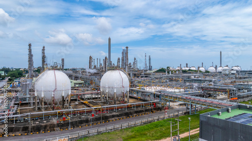 Gas separation plant at industrial estate under blue sky, Industrial gas separation plant with sphere gas storage tank, Natural gas processing plant energy infrastructure.