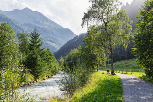 Scenic view of the Gasteiner Ache river and walkway in the Gastein Valley, Austria photo