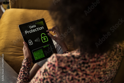 Woman accessing data on digital tablet at home
