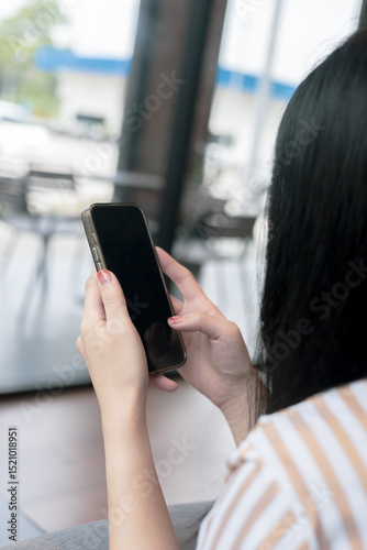 Close-up view of smartphone on hands of female in cafe on holiday. Concept for business contact interpersonal communication technology device.