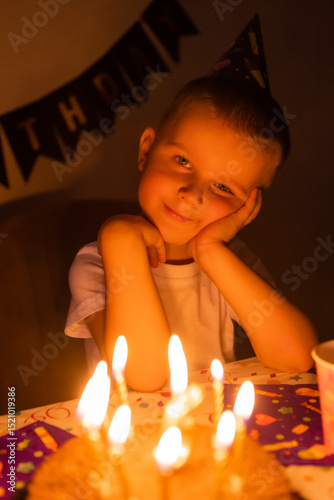 Wallpaper Mural little boy makes wishes and blows out candles on a birthday cake Torontodigital.ca