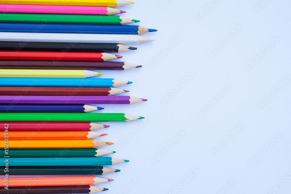 Fototapeta premium Colored pencils on a white background. background for inscriptions. School. September 1. Office. Study.
