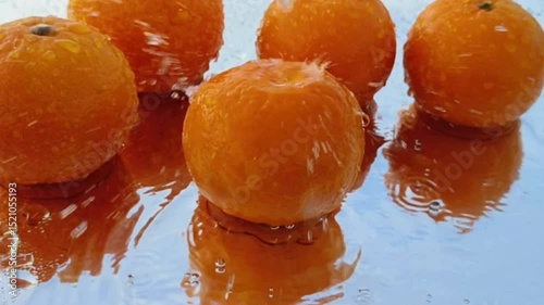 Orange with splash, drip and whirlpool. Makes a refreshing impression. Horizontal Video.