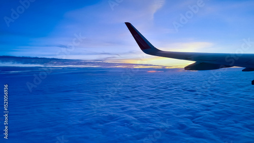 Plane travel at sunrise or sunset.