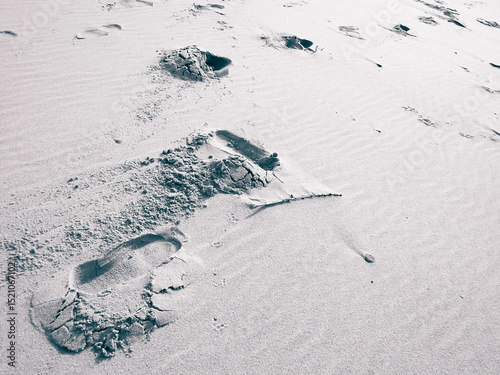 Travelers footstep on beach or desert.