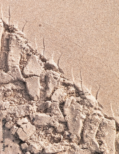 Tire track on sand of desert or beach.