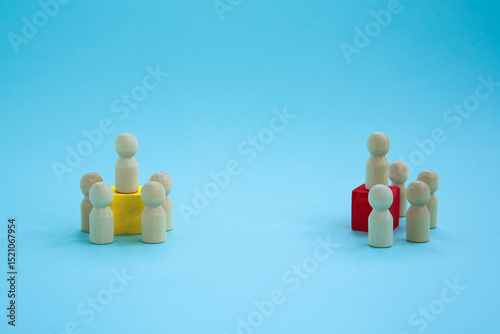 Groups and associations with leaders. Wooden figures with a red and yellow cube for the leader on a blue background. . political parties,