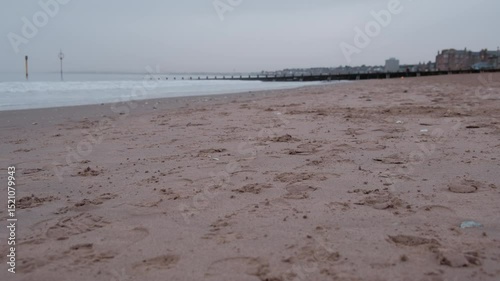 EDINBURGH, SCOTLAND, UK - JANUARY 5, 2024: Experience a peaceful morning at Portobello Beach in Edinburgh with a cloudy sunrise casting soft light over the serene shoreline.