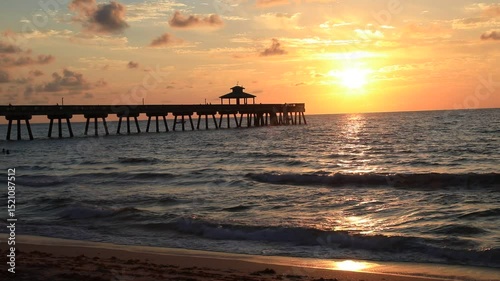 Static view of Pier 60 at Clearwater Beach Florida at Sunset, with waves in the foreground
