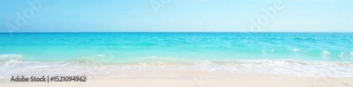 Serene, light blue water gently laps a sandy shore under a clear sky Perfect for travel, vacation, or summer themes Tranquil ocean scene evokes peace and calm , shore, ocean, marine