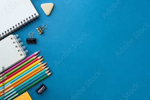 Bright school supplies on a blue background. The back to school concept
