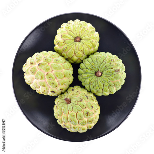 Sugar apples on black plate, vibrant and fresh