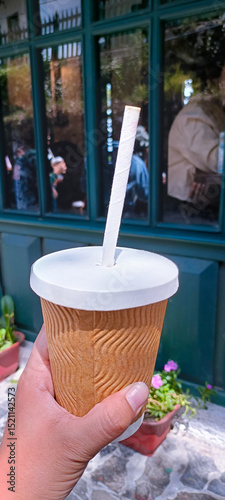 hand holding a cup of coffee