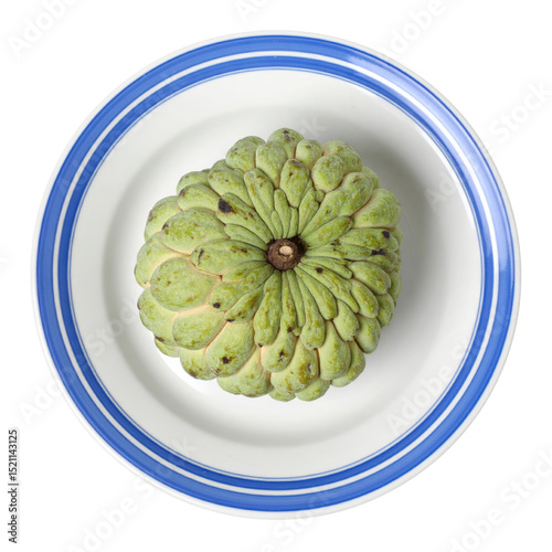 Sugar apple on white plate with blue rim