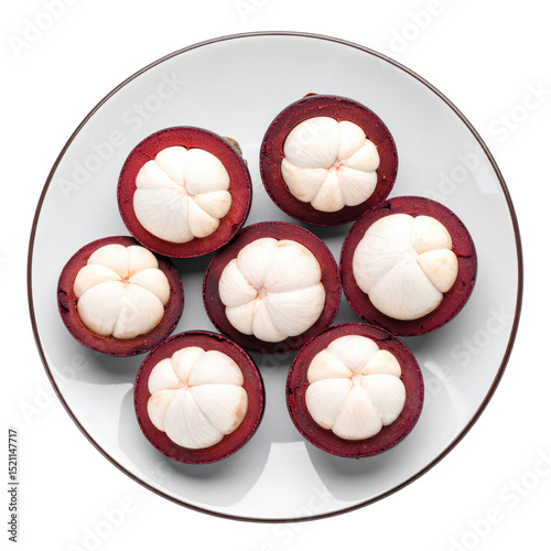 Mangosteen halves on white plate, tropical fruit delight