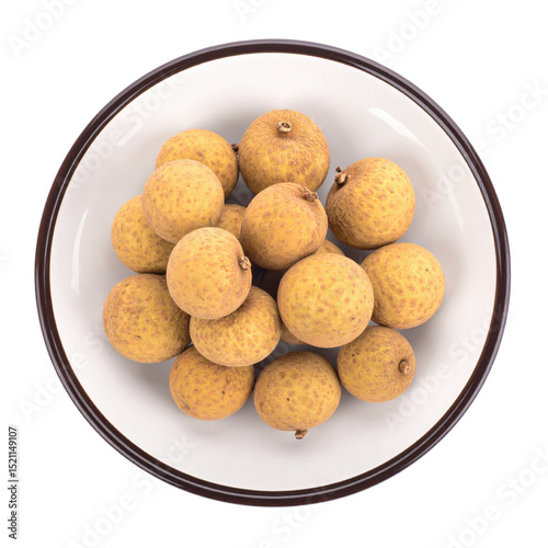 Longan fruits in white bowl, top view