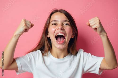 A woman celebrates with her arms raised in triumph