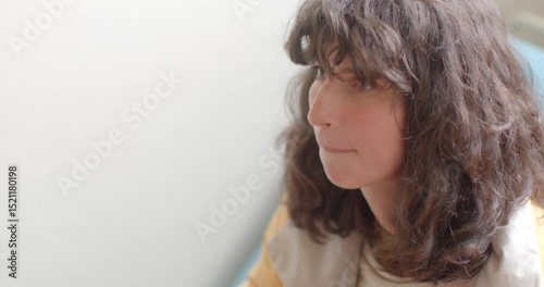 A person who has curly hair is animatedly expressing gestures during an engaging indoor conversation, showcasing the true essence of effective communication and human interaction