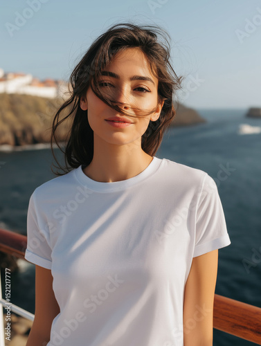 Plain White T-Shirt Worn By A Young Woman Outdoors With Ocean Background On A Sunny Day