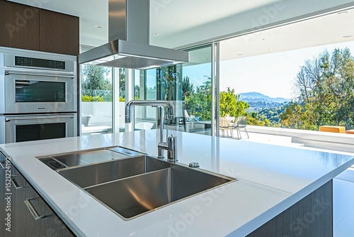 A modern home kitchen with sleek appliances and minimalistic design, bathed in soft morning light through large windows
