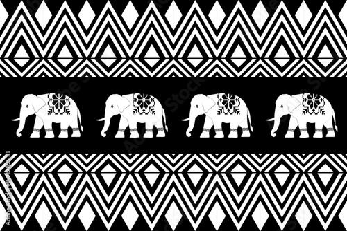 Traditional Thai tribal black and white pattern with elephants and geometric shapes. Symmetrical and detailed folk art design ideal for textiles, wallpapers, or cultural graphic projects.

