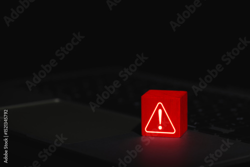 Cybersecurity Warning Alert Symbol. Glowing red warning triangle block with exclamation mark placed on laptop, symbolizing system threat or cyber security alert. system error, virus, spyware, malware,