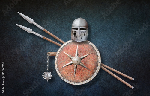 knight's helmet chain mace red shield and two spears on grunge background