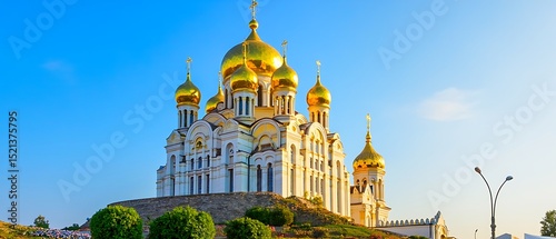 Majestic golden domed russian orthodox church against a brilliant blue sky showcasing religious architecture and cultural landmarks