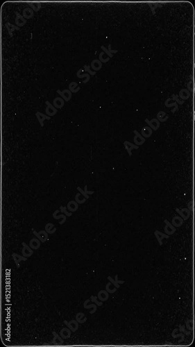 Black Old Film Overlay with Thin White Border and Grain Texture. Vintage Dust and Scratches for Authentic Retro Look. Seamless Loop for Cinematic Edits and Storytelling. Vertical Video. FL0137