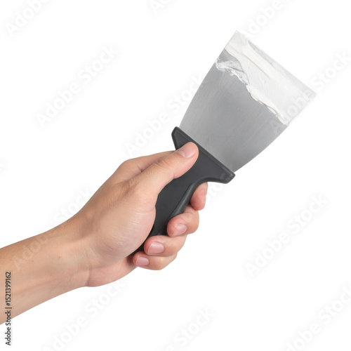 A hand holding a putty knife with a small amount of white compound on the blade.