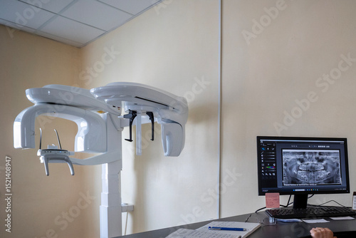 A modern X-Mind Prime panoramic dental X-ray machine, an orthopantomograph, displays a digital dental image on its monitor in a clinic setting.