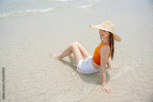 Wallpaper Mural Happy beautiful young woman smiling at the beach side - Delightful girl enjoying sunny day. Summer holiday fashion concept. Young fashion woman relax on the beach. Torontodigital.ca