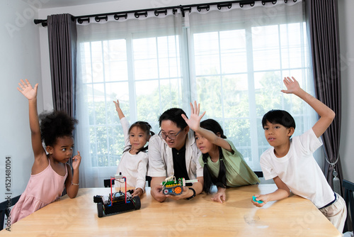 Diverse group of children learning about robotics with a teacher in a STEM class. Hands-on science and technology education in a fun and engaging classroom environment