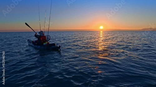 Kayak fishing angler in Mediterranean Sea sunrise