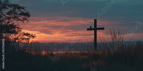 Silhouette of Wooden Cross Against Vibrant Sunset Sky