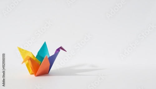 Colorful origami crane representing pride and diversity on white background