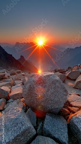 Majestic mountain sunrise landscape with a powerful flare and dramatic rock formation
