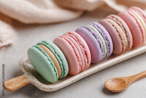 Close up of colorful pastel macarons on a plate, representing delicate French pastry, homemade baking, elegant dessert treats and delicious confectionery delights.